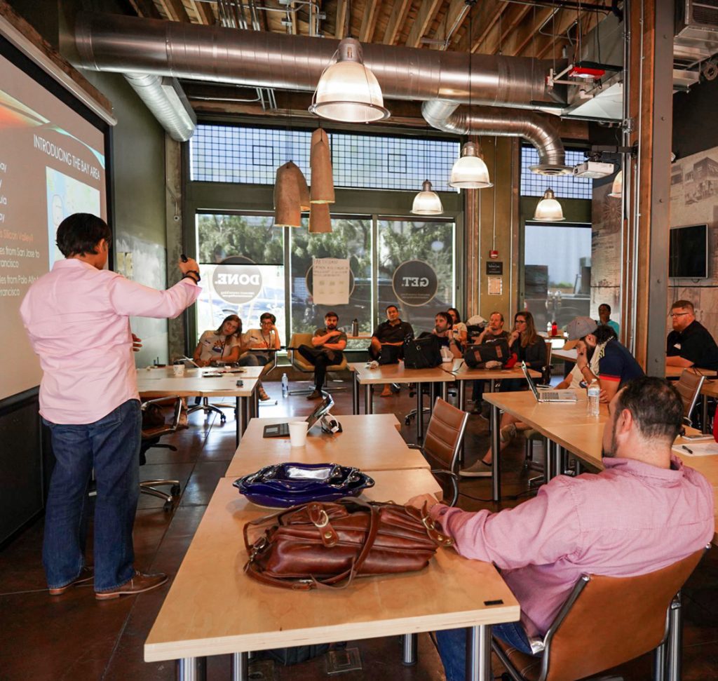 Founder presenting to entrepreneurs about advanced ecosystems